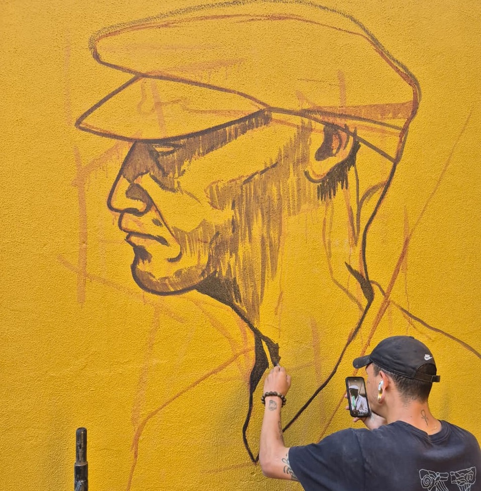 Caio Ronin pinta mural no Centro de Arte Popular em homenagem às tradições do Congado